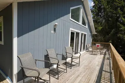 a deck with chairs and a table on a house at A gorgeous home, 5BR-2BT, perfect for your family! in Tobyhanna