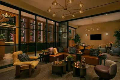 a lobby of a hotel with couches and tables at Moxy Brooklyn Williamsburg in Brooklyn
