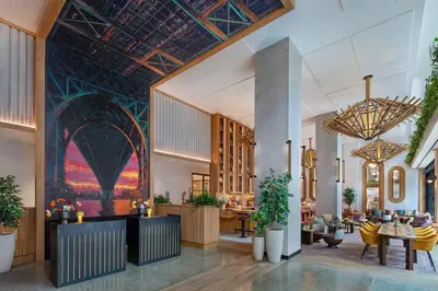 a lobby with a large painting on the wall at Moxy Brooklyn Williamsburg in Brooklyn