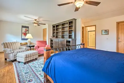 a bedroom with a blue bed and a chair at Wilmington Home on 18 Acres about 9 Mi to Skiing! in Wilmington