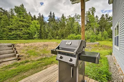 a grill sitting on a deck next to a house at Wilmington Home on 18 Acres about 9 Mi to Skiing! in Wilmington
