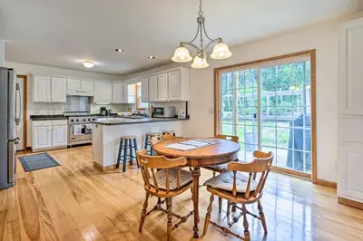 a kitchen with a wooden table and chairs at Wilmington Home on 18 Acres about 9 Mi to Skiing! in Wilmington