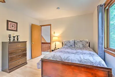 a bedroom with a bed and a dresser and a window at Bushkill House with Deck and Community Amenities! in Bushkill