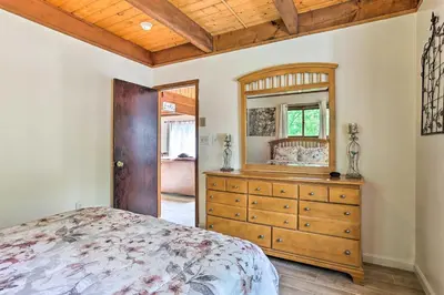 a bedroom with a wooden dresser and a mirror at Bushkill House with Deck and Community Amenities! in Bushkill
