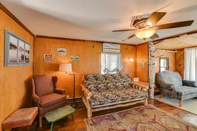 a living room with a couch and a chair at Rustic Caroga Lake Retreat Fish, Hike and Ski! in Caroga Lake