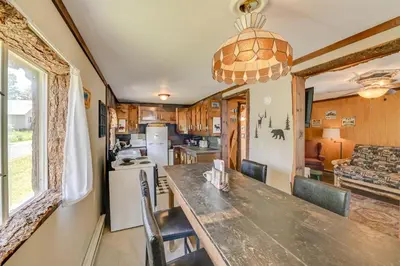 a kitchen and dining room with a table and chairs at Rustic Caroga Lake Retreat Fish, Hike and Ski! in Caroga Lake