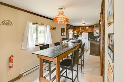 a kitchen and dining room with a table and chairs at Rustic Caroga Lake Retreat Fish, Hike and Ski! in Caroga Lake