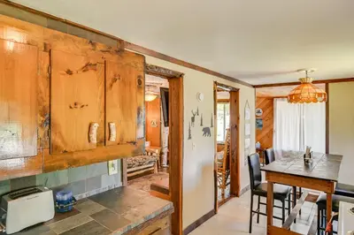 a kitchen and dining room with a table and chairs at Rustic Caroga Lake Retreat Fish, Hike and Ski! in Caroga Lake