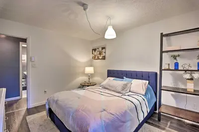 a bedroom with a bed with a blue head board at 7 Mi to Tobyhanna State Park Quiet Retreat! in Tobyhanna