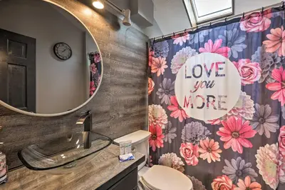 a bathroom with a sink and a mirror and a toilet at 7 Mi to Tobyhanna State Park Quiet Retreat! in Tobyhanna