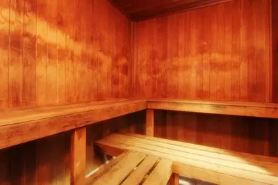 a wooden sauna with a wooden bench in it at The Ponds at Foxhollow in Lenox