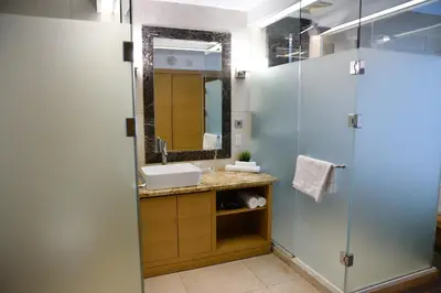 a bathroom with a sink and a shower at The One Boutique Hotel in Queens