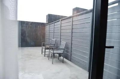 two chairs and a table on a balcony at The One Boutique Hotel in Queens