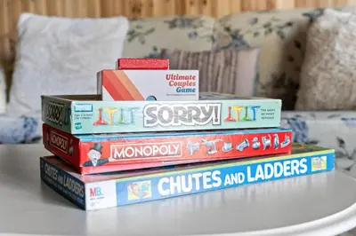a stack of books sitting on top of a table at Ski In Ski Out Cabin on Hunter Mtn Seasonal Pool Access w Panoramic Views Hike Swim Fish Relax in Lanesville