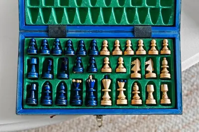 a chess set in a blue box with chess pieces at Ski In Ski Out Cabin on Hunter Mtn Seasonal Pool Access w Panoramic Views Hike Swim Fish Relax in Lanesville