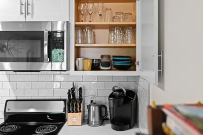 a kitchen with a counter with a microwave and a stove at Ski In Ski Out Cabin on Hunter Mtn Seasonal Pool Access w Panoramic Views Hike Swim Fish Relax in Lanesville