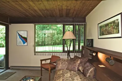 a living room with a couch and a window at The Cottage in Stockbridge