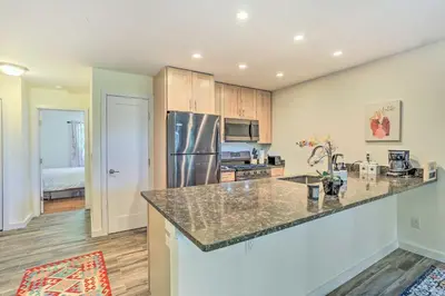a kitchen with a counter top and a refrigerator at Sun-Lit Vernon Condo Less Than 2 Mi to Ski Resort! in Vernon Township