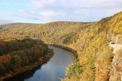 a river in the middle of a valley with trees at Spacious Catskills Serenity nearby Delaware River Gap w Game Rm Pet Friendly and Fenced Yard in Glen Spey