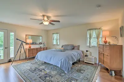 a bedroom with a bed and a ceiling fan at Ashley Falls Home with Fire Pit Hike and Ski! in Ashley Falls