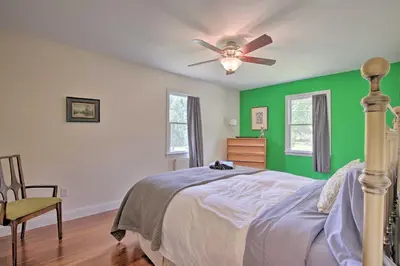 a bedroom with green walls and a bed with a ceiling fan at Ashley Falls Home with Fire Pit Hike and Ski! in Ashley Falls