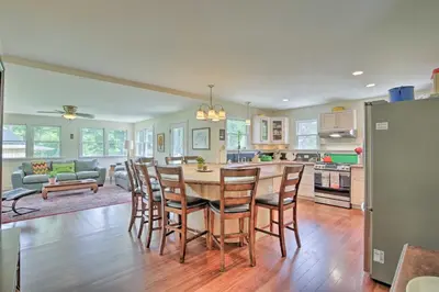 a kitchen and dining room with a table and chairs at Ashley Falls Home with Fire Pit Hike and Ski! in Ashley Falls