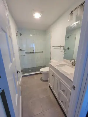 a bathroom with a toilet and a sink and a mirror at The Hidden Inn in South Kortright