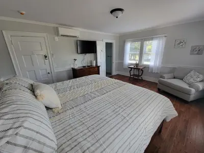 a bedroom with a large bed and a couch at The Hidden Inn in South Kortright