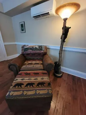 a living room with a couch and a lamp at The Hidden Inn in South Kortright