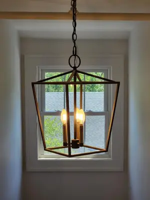 a chandelier hanging in front of a window at The Hidden Inn in South Kortright