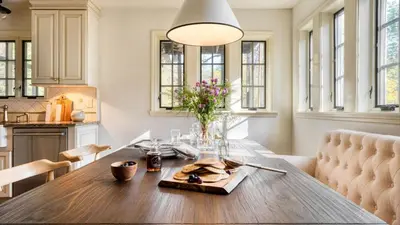 a kitchen and dining room with a wooden table at 4BDR Heritage Estate w Pool Private Pond Fire Pit Cortland by AvantStay in Saugerties