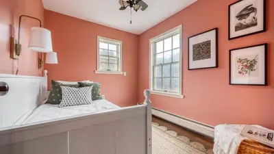 a bedroom with orange walls and a bed at 4BDR Heritage Estate w Pool Private Pond Fire Pit Cortland by AvantStay in Saugerties