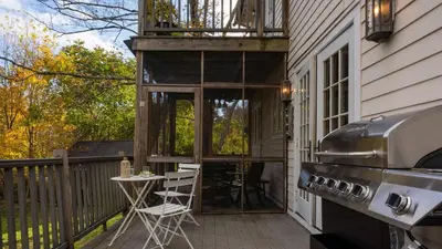 a screened in porch with a table and a grill at 4BDR Heritage Estate w Pool Private Pond Fire Pit Cortland by AvantStay in Saugerties