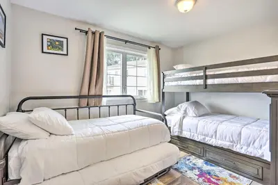 a bedroom with two bunk beds and a window at Ideally Located Glen Cove Apartment! in Glen Cove