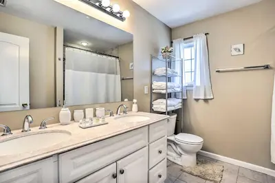 a bathroom with a sink and a toilet and a mirror at Ideally Located Glen Cove Apartment! in Glen Cove