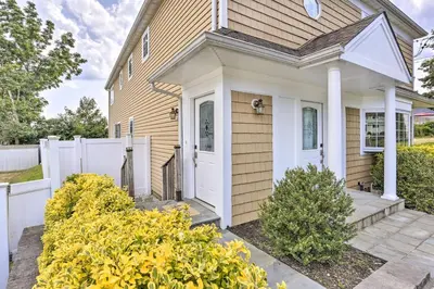 a house with a white door and a fence at Ideally Located Glen Cove Apartment! in Glen Cove
