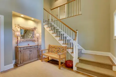 a staircase in a home with a wooden stair case at Stunning Warren Lakefront Home Deck, Grill, Sauna in Warren