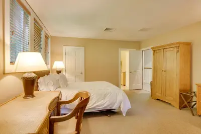 a bedroom with a bed and a desk with a lamp at Stunning Warren Lakefront Home Deck, Grill, Sauna in Warren