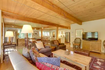 a living room with a couch and a table at Stunning Warren Lakefront Home Deck, Grill, Sauna in Warren
