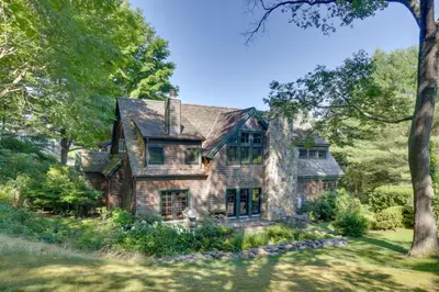 an old stone house in the woods with trees at Stunning Warren Lakefront Home Deck, Grill, Sauna in Warren