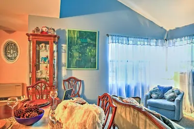 a dining room with a table and chairs and a blue wall at Malta House with Pool 9 Mi to Saratoga Race Course! in Ballston Spa