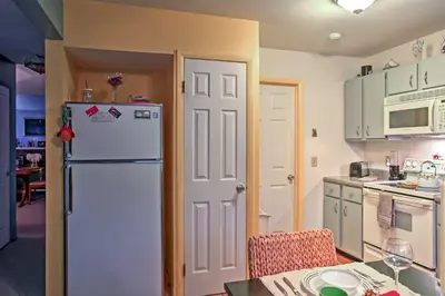 a kitchen with a white refrigerator and a table at Malta House with Pool 9 Mi to Saratoga Race Course! in Ballston Spa