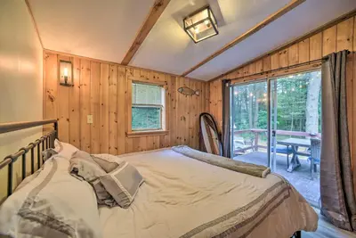 a bedroom with a bed and a large window at Glamping Getaway in Woodstock Lake Campground in East Berne