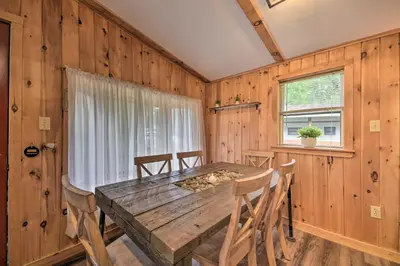 a dining room with a wooden table and chairs at Glamping Getaway in Woodstock Lake Campground in East Berne
