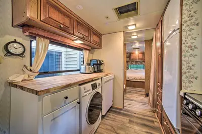 a kitchen with a washer and dryer in a caravan at Glamping Getaway in Woodstock Lake Campground in East Berne