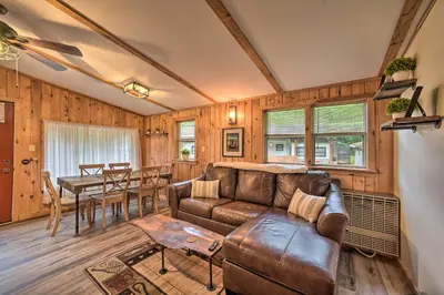 a living room with a couch and a table at Glamping Getaway in Woodstock Lake Campground in East Berne