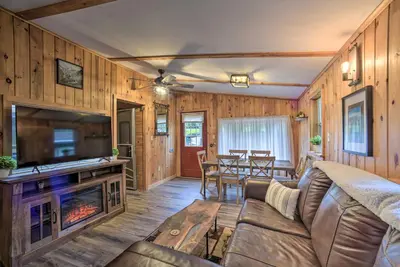 a living room with a couch and a fireplace at Glamping Getaway in Woodstock Lake Campground in East Berne