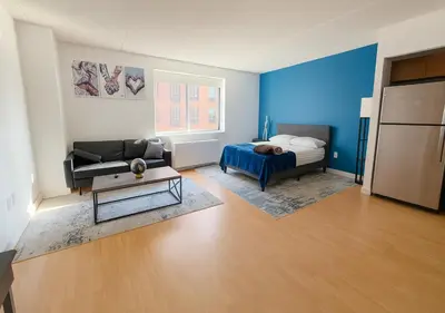 a living room with a bed and a couch at Studio apart Time Square in New York