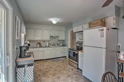 a kitchen with white cabinets and a white refrigerator at Saratoga Springs Haven with Pool and Fire Pit! in Saratoga Springs