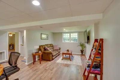 a living room with a couch and a table at Saratoga Springs Haven with Pool and Fire Pit! in Saratoga Springs